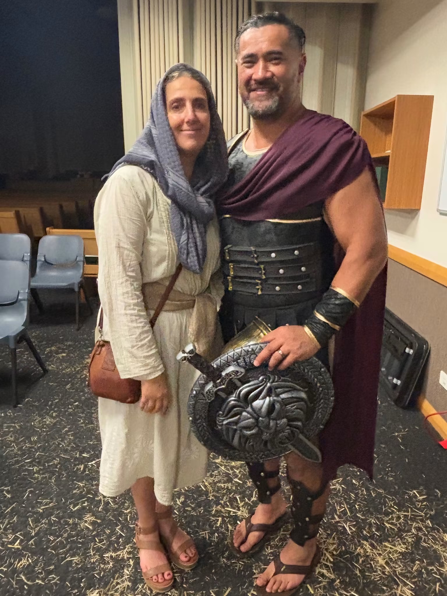 A villager and a Roman soldier in costume indoors before the performance